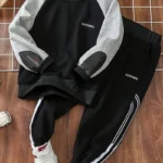 a black and grey sweater and pants