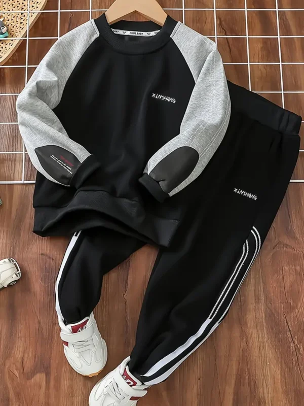a black and grey sweater and pants
